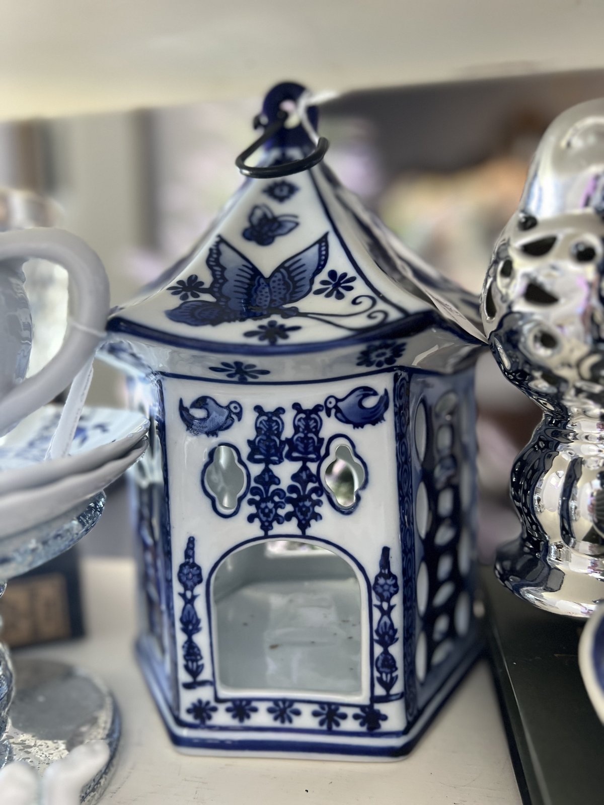 Blue and white porcelain pagoda-shaped candle lantern with butterfly motif